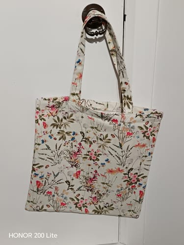 Customer's tote bag made from the floral Antique Garden Cotton Canvas Fabric, hanging on a door handle.