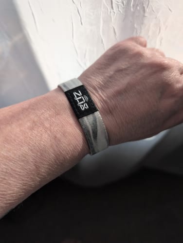 Reviewer wearing the Selah Bible Verse Bracelet with a muted, wavy pattern on their wrist.