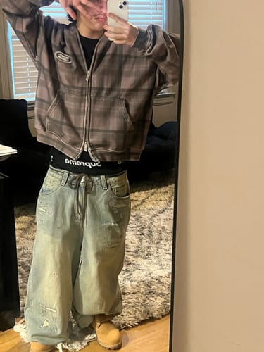 Reviewer wearing the brown Plaid Zip Hoodie in a full-length mirror selfie to show the fit.