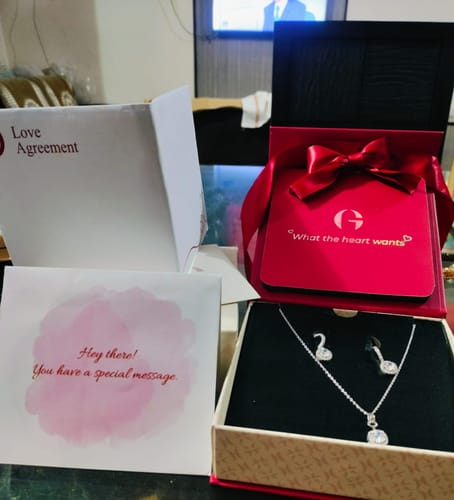 Customer's Silver Twilight Solitaire Set displayed in its red gift box, showing the necklace and earrings.