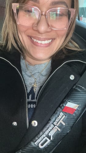 A smiling customer wearing the 14K Hollow Cuban Curb Chain with a cross pendant.