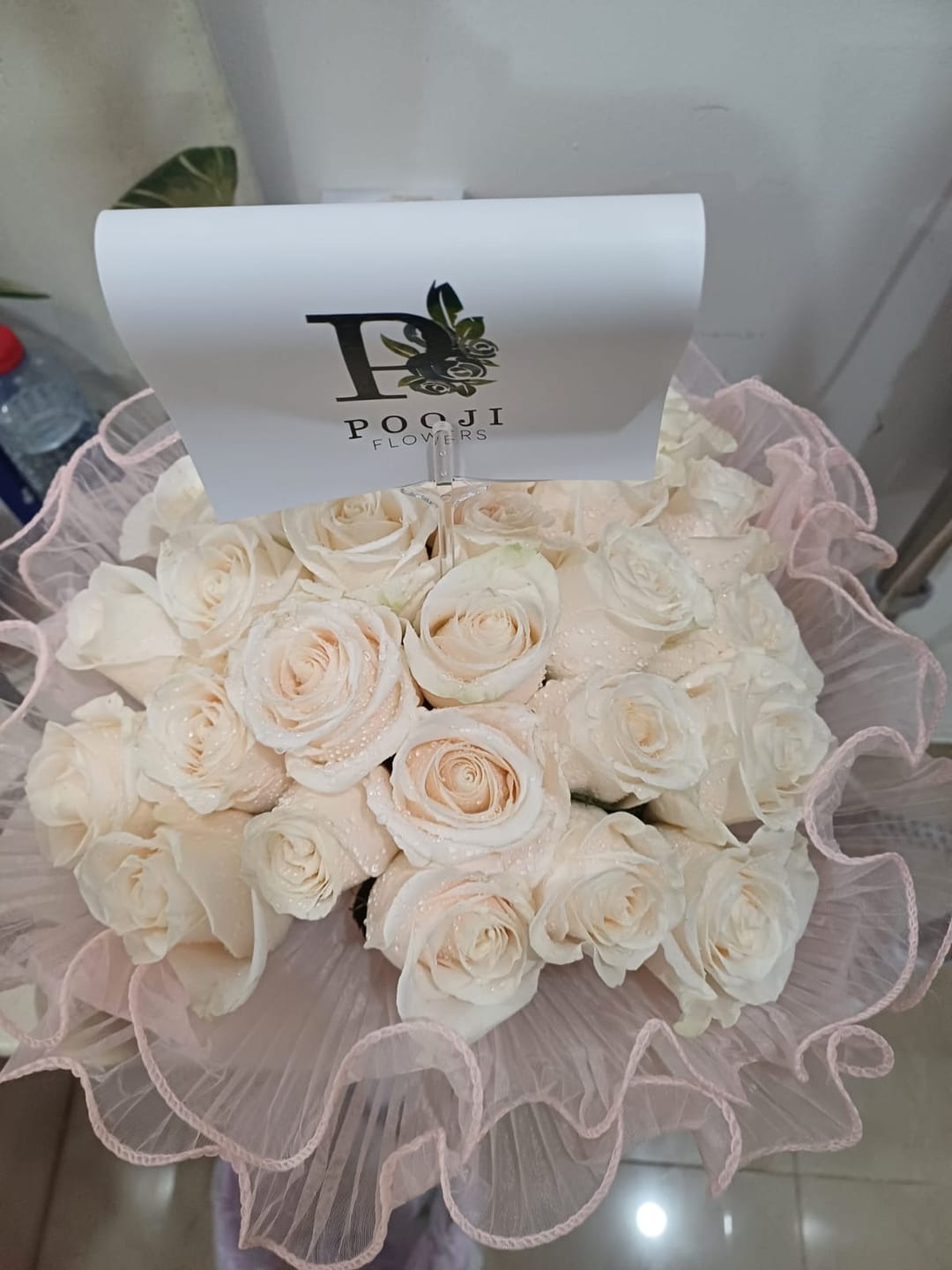 Customer photo review of White Roses Pink Wrap - 25 Stems