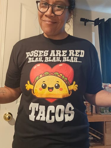 Reviewer happily modeling the black Valentine's Day Tacos T-Shirt with its funny taco graphic.