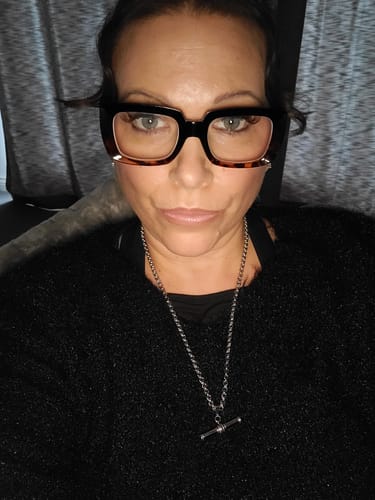 Customer wearing the XL T-Bar Necklace silver against a black sweater.