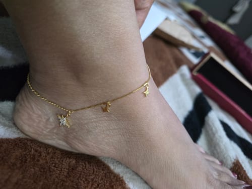 Reviewer wearing the elegant Golden North Star Anklet, showing the shiny zircon star and other charms.
