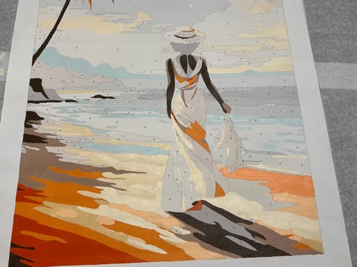 Customer's paint-by-numbers canvas of a woman on a beach, a project used with the Adjustable Artist Easel.
