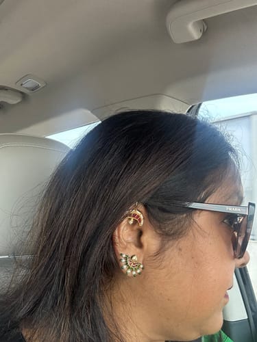 Reviewer wearing the gold Archita Earcuff on their upper ear, paired with another earring.