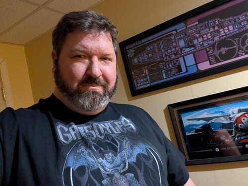 Reviewer wearing the black Joyride Gargoyles T-Shirt with its prominent front graphic.