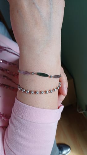 Reviewer wearing the delicate Elise bracelet on their wrist next to another bracelet.