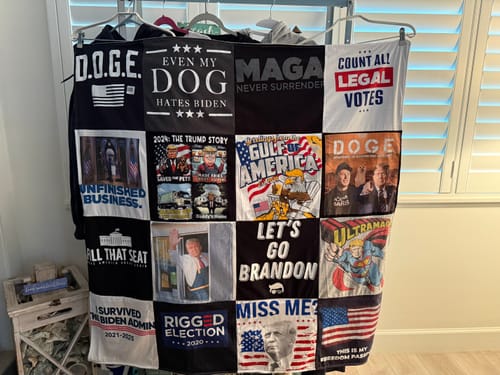 Customer's finished Premium T Shirt Quilt made from t-shirts with political themes, hung for display.