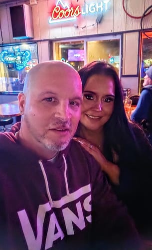 Reviewer and their partner smiling for a photo at a bar, enjoying the birthday celebration described in their review.