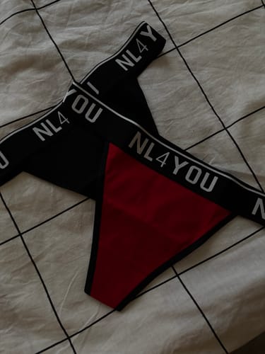 Customer's red and black cotton thongs laid out, showing the NL4YOU waistband.