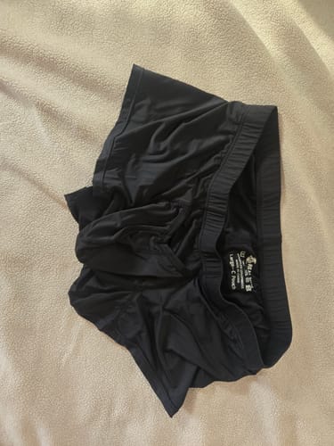 Customer's black Nylon V-Fly Boxer Briefs lying on a textured surface, with the 'Large C Pouch' tag visible inside.