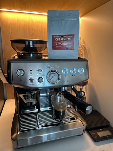Customer's surprise coffee from their weekly plan, sitting on an espresso machine while brewing.