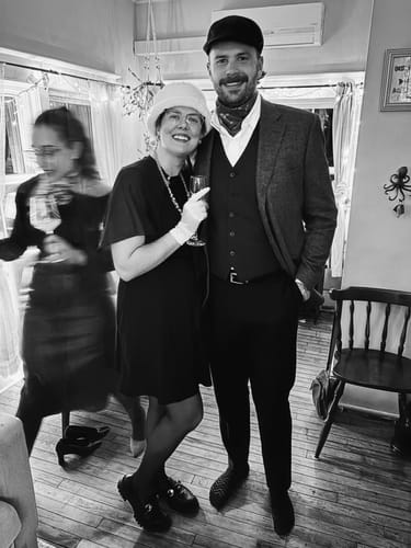 Customer and a guest in 1950s costumes enjoying the Broadway Murder Mystery Game Kit.