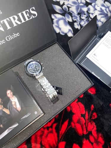 Customer showing the new Schuyler watch with a stainless steel band inside its open black presentation box.
