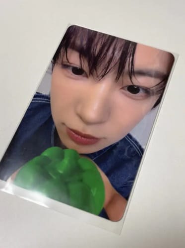 Customer's ALPHA DRIVE ONE "EUPHORIA" photocard showing a person in a denim jacket holding a green bell pepper.