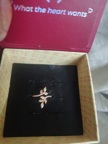 Customer's Rose Gold Pure Poise Ring with a shiny leaf design, shown inside its open presentation box.