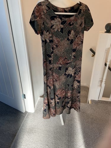 Customer's finished short-sleeve dress made from the sparkly Diamante Printed Winter Viscose, hanging on a hanger.