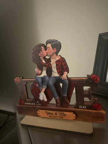 Customer's personalized wooden LOVE plaque with a kissing couple on top. The names Mariluce and Elio are visible.