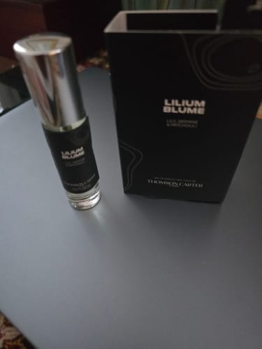 Reviewer's Lilium Blume Eau de Parfum 2ml sample bottle sitting next to the black product box.