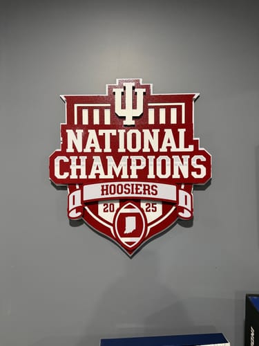 Customer's red and white Indiana Hoosiers 3D metal wall art mounted on a plain grey wall.