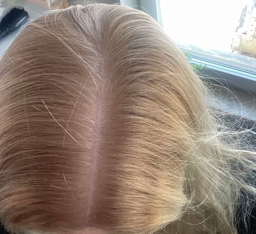 Customer's hair parting from above, showing light golden blonde results after using the Sunkissed Starter Kit.