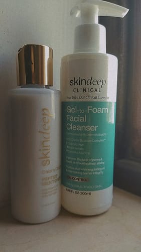 Customer's Dream Glaze Peptide Milk Toner bottle with a gold cap, shown next to a facial cleanser.