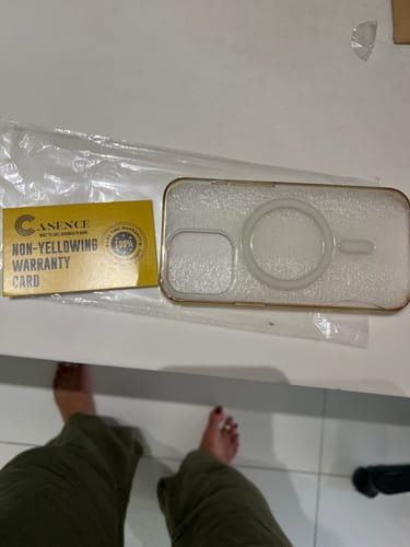 Customer's Anti Yellow Magsafe Transparent Clear Case for iPhone 13 Pro on a desk with its warranty card.