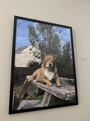 Customer's completed Paint Your Pet by Numbers portrait of a tan dog, framed and hanging on a wall.