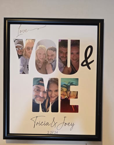 Customer's 'You & Me' personalized poster in a black frame, featuring photos of a couple within the letters and custom text.