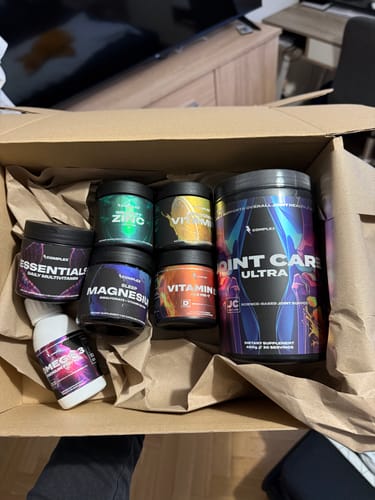 Customer's tub of Joint Care Ultra inside an open shipping box with other supplement containers.