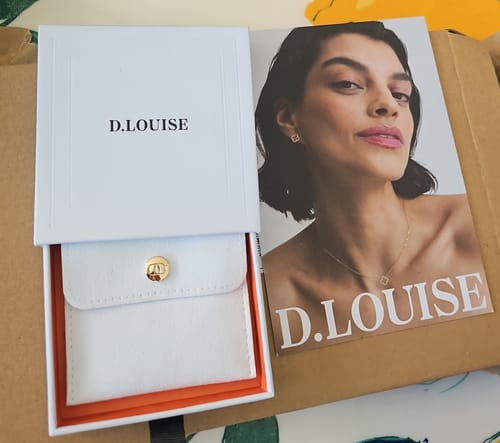 Customer showing the elegant D. Louise packaging for their Luxe Tennis Necklace.