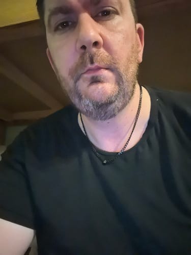 Customer provides a close-up view of the black Legacy Necklace worn with a t-shirt.