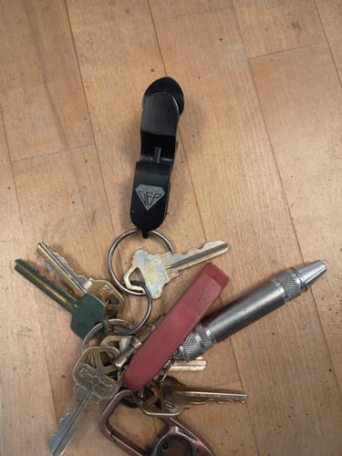 Customer's black Premium Shotgun Tool attached to a full keyring with several other keys and tools.