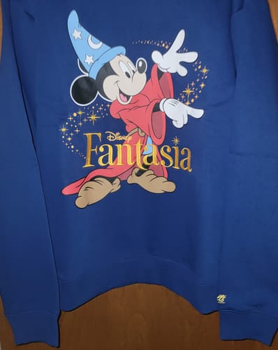 Customer's blue Fantasia sweatshirt, featuring the 'Magic Mickey' graphic with gold lettering.