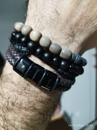 Close-up of a reviewer wearing the braided leather Olaf bracelet with its custom engraved beads.