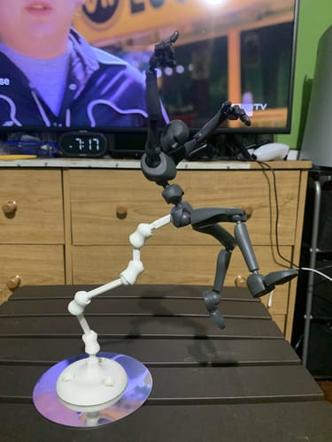 Reviewer's Stickybones Figure held in a dynamic mid-air pose by the white Fly-Rig.