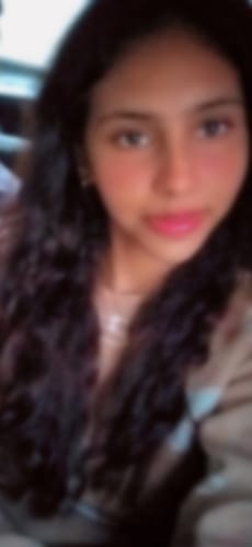 Close-up of a reviewer's long hair with defined curls after using the Curl Enhancing Gel.