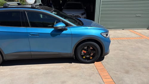 Customer's Braumach Space Saver Spare Wheel fitted on the front of a blue car.