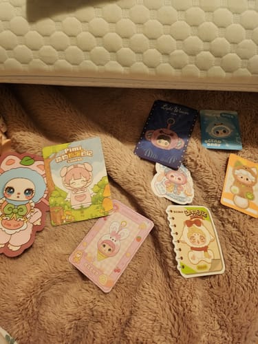 Customer shows several colorful collectible cards received from the KikaGoods Plush Toy Lucky Bag.