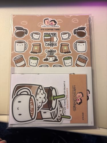 Customer's Coffee Lovers Sticker Set in packaging, showing cute illustrated sticker sheets and larger die-cut stickers.