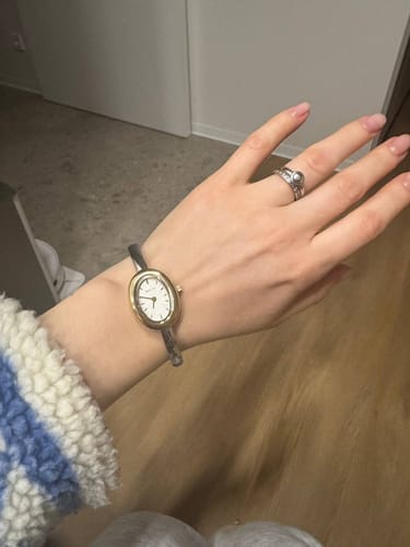 A customer's wrist showing the elegant Diana Gold Silver watch with its oval gold face.