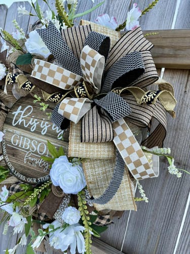 Customer's handmade wreath showing the black and gold foil leaf ribbon used in a layered bow.