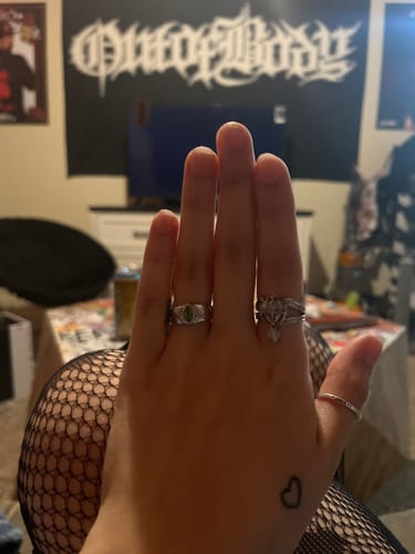 Customer's hand wearing the BIRTHSTONE RING (MAY) on their index finger, showing the green stone.