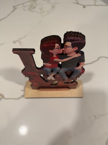 Reviewer's Eternal LOVE wooden plaque viewed from the side on a white countertop.