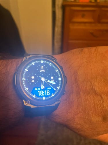 A customer's Gard Pro Ultra 3 watch on their wrist, showing the large, illuminated smart face with various dials.