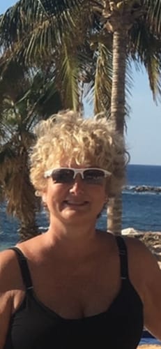 Reviewer smiling outdoors, showing glowing skin from the Grass Fed Tallow & Honey Balm.