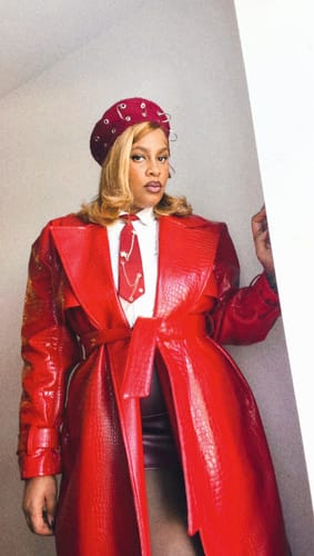 Customer in a bright red Vegan Leather Croc Trench Coat, showing the croc texture and wide lapels.