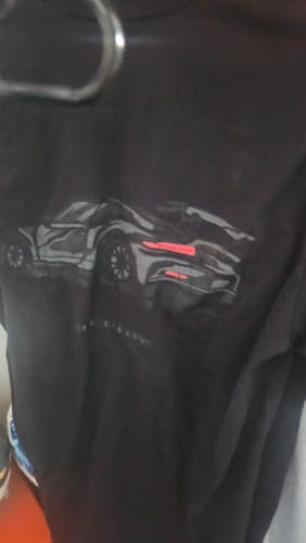 Partial view: Customer's black 80Eighty® Limited Edition DCG85 Shirt hanging up, showing the graphic of a car.
